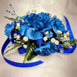 Blue carnation corsage with white baby's breath and ribbon
