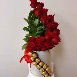 Red roses in a white hatbox with a red ribbon and Ferrero Rocher chocolates