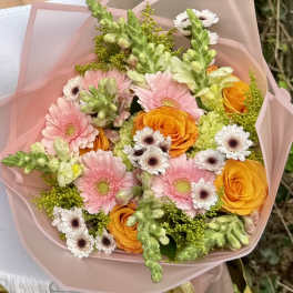Pink and orange mixed bouquet wrapped in blush paper