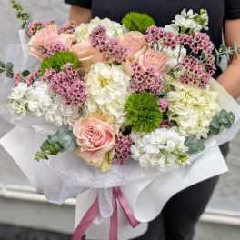 Bouquet of pink roses, white hydrangeas, and small pink filler flowers