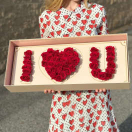 Boxed red rose arrangement spelling I love you