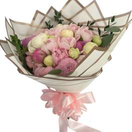 Bouquet of pink and cream peonies wrapped in translucent paper with a pink ribbon