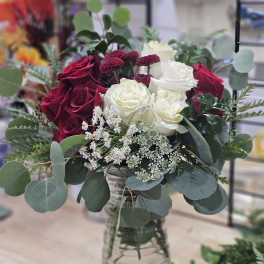 Bouquet of red and white roses in a glass vase