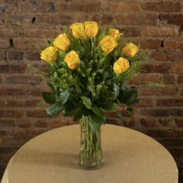 Yellow roses arranged in a clear glass vase