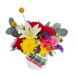 Colorful bouquet in a white bucket with crayons on the front