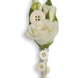 White rose boutonniere with ivory buttons on a silver-wrapped stem