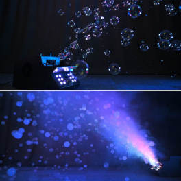 Blue-lit bubbles floating in a dark room with a fog machine on the floor.