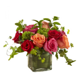 Mixed roses in a clear glass vase