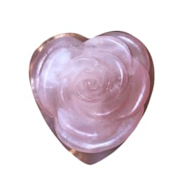 Pink rose-shaped decorative object on a white background