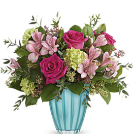 Pink roses and alstroemeria in a turquoise vase