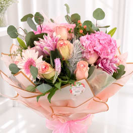 Pink and peach bouquet with roses, hydrangea, and gerbera daisies