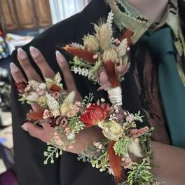 Floral wrist corsage and matching boutonniere with dried blooms and ribbon