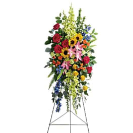 Tall standing floral spray with mixed colorful flowers on an easel