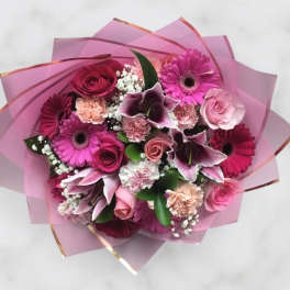 Pink bouquet with roses, gerbera daisies, lilies, and carnations