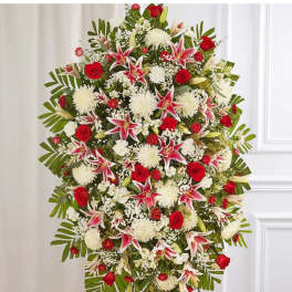 Standing spray of red roses, white mums, and pink lilies