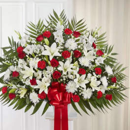 Large red and white floral spray with a red ribbon bow