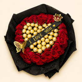 Red rose bouquet with gold-wrapped chocolates and a black ribbon