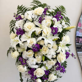 White and purple floral arrangement with roses and lilies