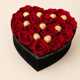 Heart-shaped box of red roses with gold-wrapped chocolates