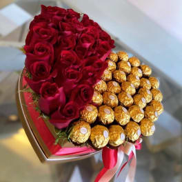 Heart-shaped bouquet of red roses and gold-wrapped chocolates