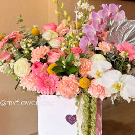 Mixed pink and white flower arrangement in a white gift box