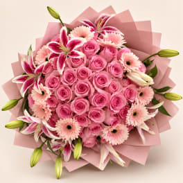 Pink rose bouquet with lilies and gerbera daisies wrapped in pink paper