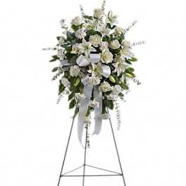 White funeral spray on a standing easel with ribbon