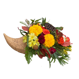 Tropical bouquet with yellow and orange flowers in a woven horn-shaped container