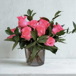 Pink roses arranged in a clear glass vase