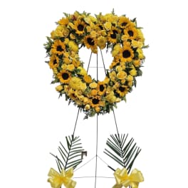Yellow floral heart wreath on a standing easel with ribbon bows