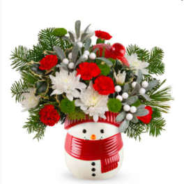 Christmas bouquet in a snowman vase with red and white flowers
