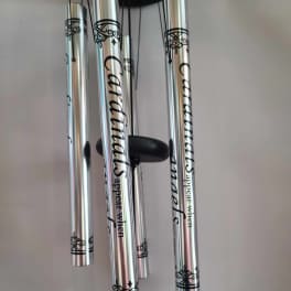 Silver wind chimes with black decorative text and scrollwork