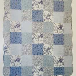 Blue and white patchwork quilt with floral prints