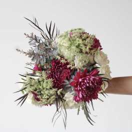 Handheld bouquet of magenta and white flowers with airy filler