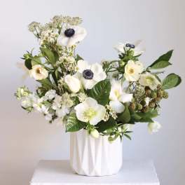 White floral arrangement in a textured white vase