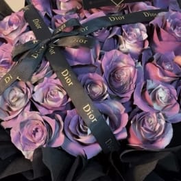 Purple and pink roses tied with black Dior ribbons