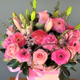 Pink mixed bouquet in a white gift box with a ribbon