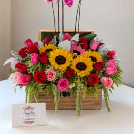 Wooden box arrangement with roses, sunflowers, and pink orchids