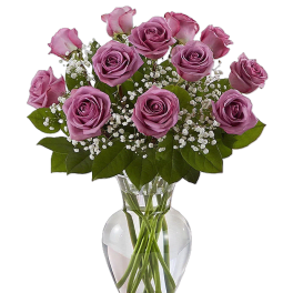 Pink roses arranged in a clear glass vase with baby's breath