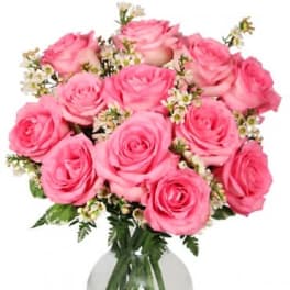 Pink roses arranged in a clear glass vase