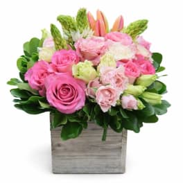 Pink roses and lisianthus in a wooden box