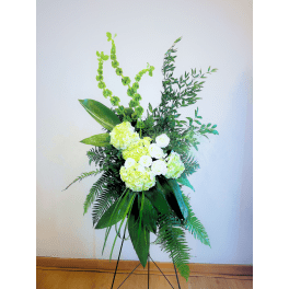 Tall floral standing arrangement with white and pale green blooms