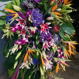 Large tropical floral spray with purple hydrangeas and orange bird-of-paradise blooms