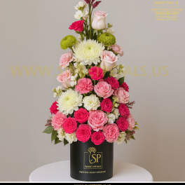 Tall pink and white floral arrangement in a black cylinder box