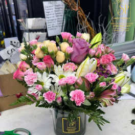 Mixed pink and white bouquet in a black vase