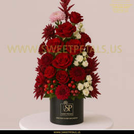 Red roses and white spray roses arranged in a black box