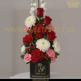 Tall red rose arrangement with white and pink flowers in a black box
