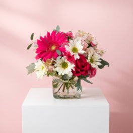 Pink and white mixed bouquet in a clear glass vase