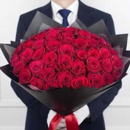 Large bouquet of red roses wrapped in black paper