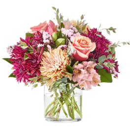 Pink and peach mixed bouquet in a clear glass vase